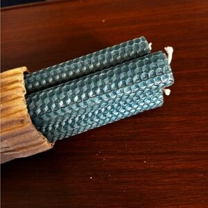 Christmas green four count pillar candles made out of beeswax.